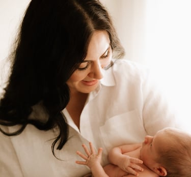 Tender moment between baby and parents, part of a newborn lifestyle photography session in Adelaide