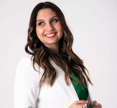 a woman in a white coat and green tie