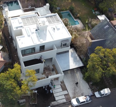 a house with a pool and a pool in the background