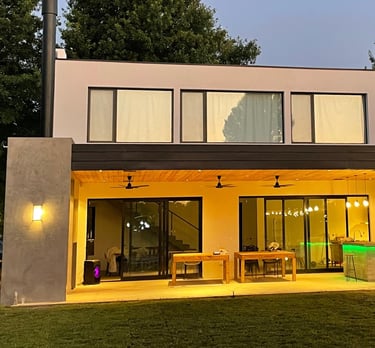 a house with a large backyard area and a patio area