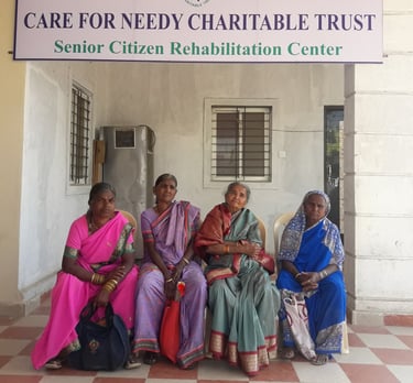 a group of women sitting on a bench in front of a sign