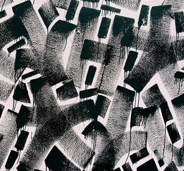 a black and white photograph of a graffiti filled wall