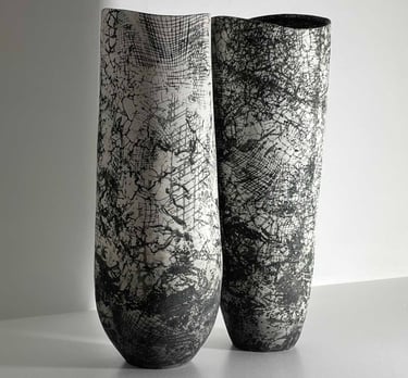 Two classically designed black and white ceramic vases 