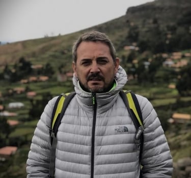 a man in a grey jacket and a backpacker