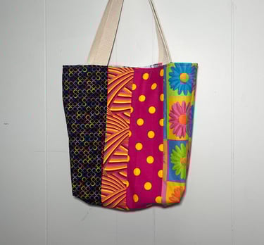  a colorful patchwork bag hanging on a wall
