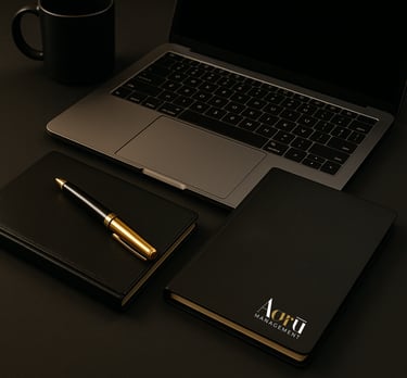 Aaru notebook and pen beside laptop