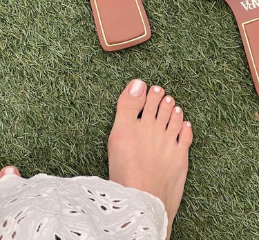 a person's feet and a pair of sandals