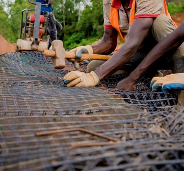 Close-up of geogrid reinforcement being installed for soil stabilization.