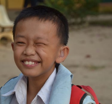 a young boy with hearing aid on his head
