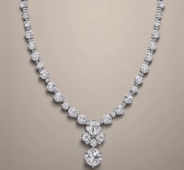 An elegant gold necklace with a delicate diamond pendant, artfully displayed on a minimalist white marble surface.