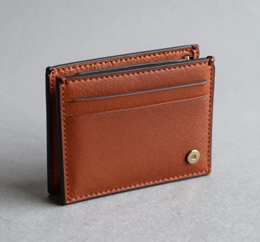 A close-up of hands holding a gift box wrapped with a discount coupon attached.