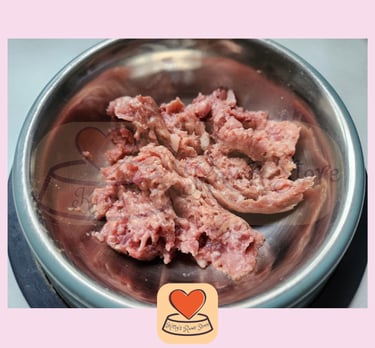 An image of raw cat food in a stainless steel bowl