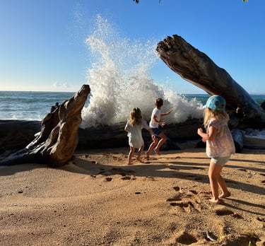 Kids playing in the ocean in Kauai Hawaii