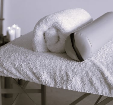 Une table de massage avec des coussins.