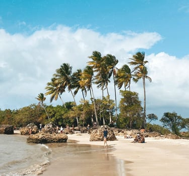a person walking on a beach near a body of water in Morro de São Paulo, Bahia, Brazil