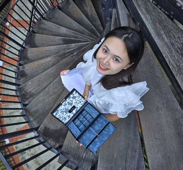 girl looking up from spiral staircase | olio my shop