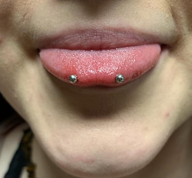 a woman with a snake eyes piercing