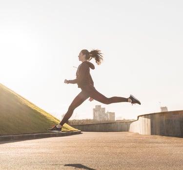 a woman is running in the sun