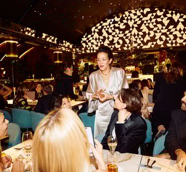 a woman in a silver jacket and a man in a suit and tie