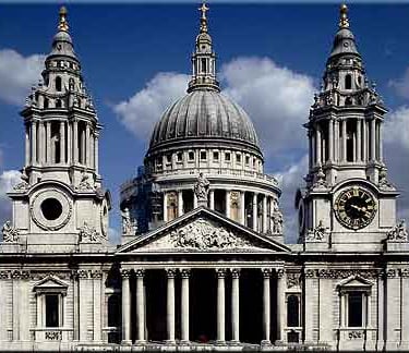 a large white portland stone building with a clock tower in the middle