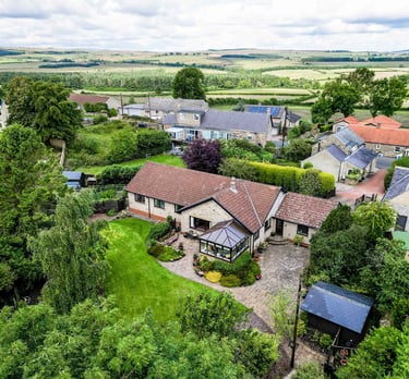 a house with a large garden and a large lawn