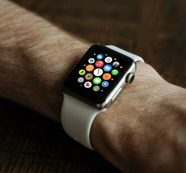 a person holding a smart watch in their hand