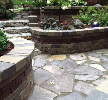 Leppek Landscapes designed and installed flagstone patio, ledge rock steps, and retaining walls.