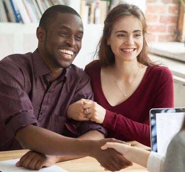 a man and woman shaking hands in a meeting