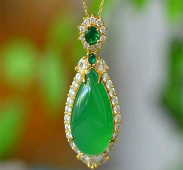 a green necklace with a green tear shaped pendant