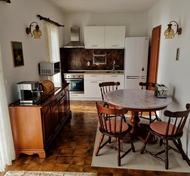 The photo shows the apartment's kitchen and dining area from an elevated perspective.