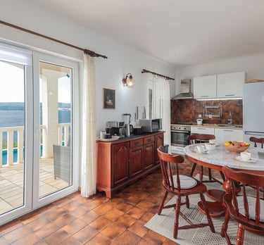 The photo shows the apartment's kitchen and dining area with household appliances.