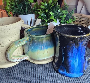 a table with a bunch of different colored mugs