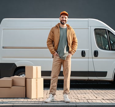 a man standing in front of a van with boxes