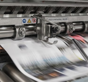 Industrial offset printing press machine processing high-speed full-color magazines.