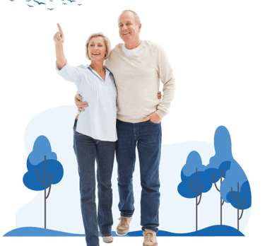 A happy senior couple walking outdoors together with the woman pointing towards birds in the sky.