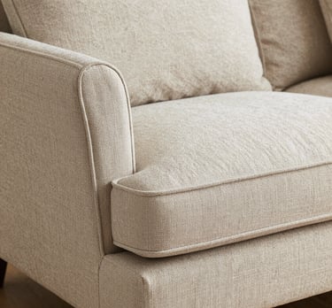 Cozy living room corner with a plush sofa and warm lighting.