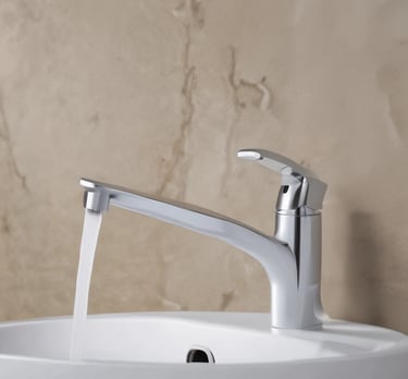 Modern brushed nickel pull-down kitchen faucet with a high-arc spout on a marble countertop.