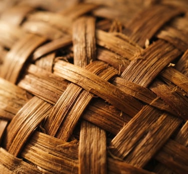 Macro detail shot of woven organic bamboo fibers, warm natural side-lighting, rich brown and gold tones, shallow depth of field, 35mm editorial photography