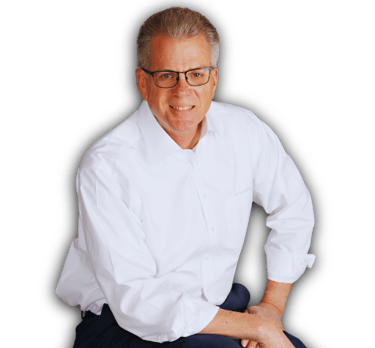 Dale Usher wearing a white shirt and glasses