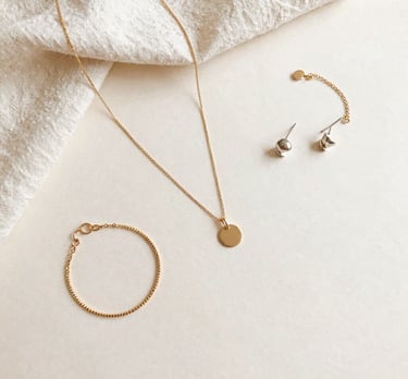 A stylish bracelet featuring semi-precious stones on a rustic wooden table.