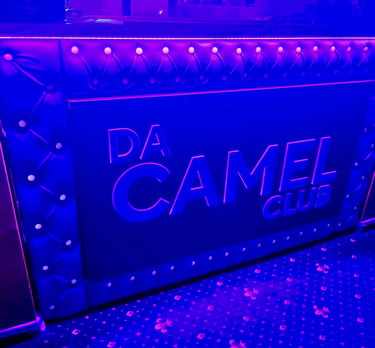 Royal blue tufted leather texture with sparkling crystal diamond buttons in a diamond pattern.