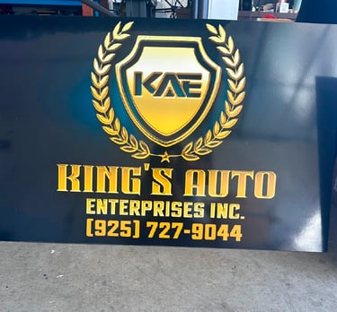 King's Auto Enterprises Inc. custom black sign with gold 3D lettering and shield logo.