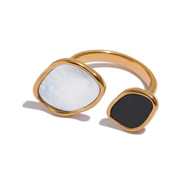 Gold open ring featuring organic shaped white shell and black onyx stone accents.