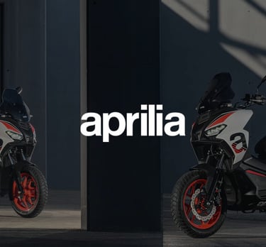 a motorcycle parked in front of a building with the words april on it