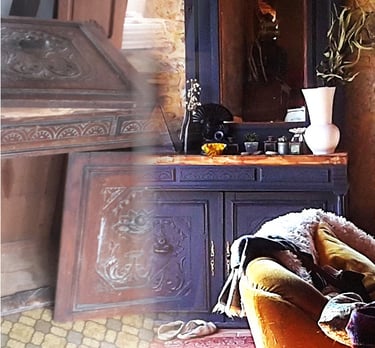 Rustic vintage blue wooden sideboard with ornate carvings in a cozy living room setting.