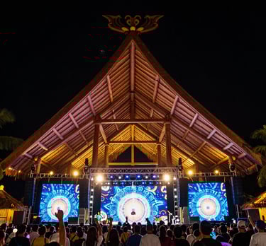 a crowd of people watching a stage with a large crowd watching
