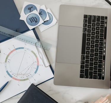 a laptop computer sitting on a desk with a birth chart