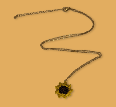 a necklace with a sunflower on it
