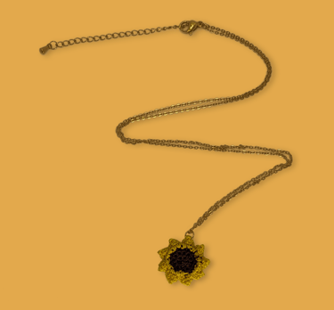 a necklace with a sunflower on it