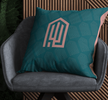 elegant cushion with the Jalit Home Decor visual identity under a sophisticated armchair